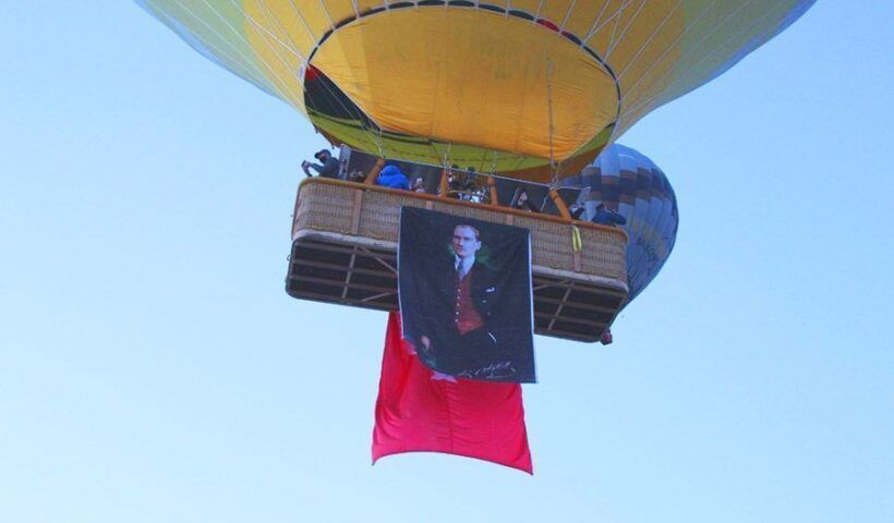 Turkey, balloons in Cappadocia with flags and portraits of Atatürk