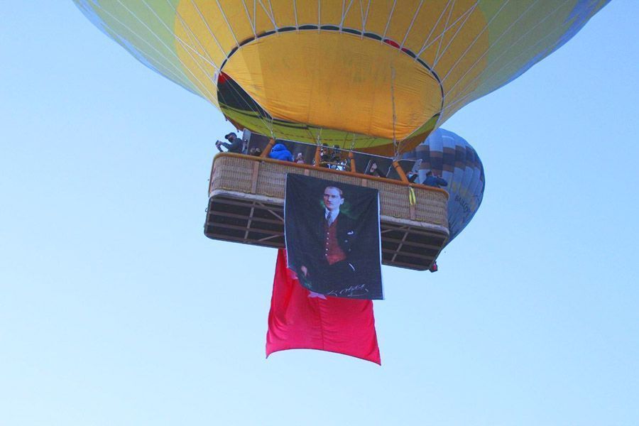 Turkey, balloons in Cappadocia with flags and portraits of Atatürk