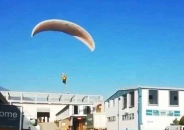 Turkey, man commutes paragliding