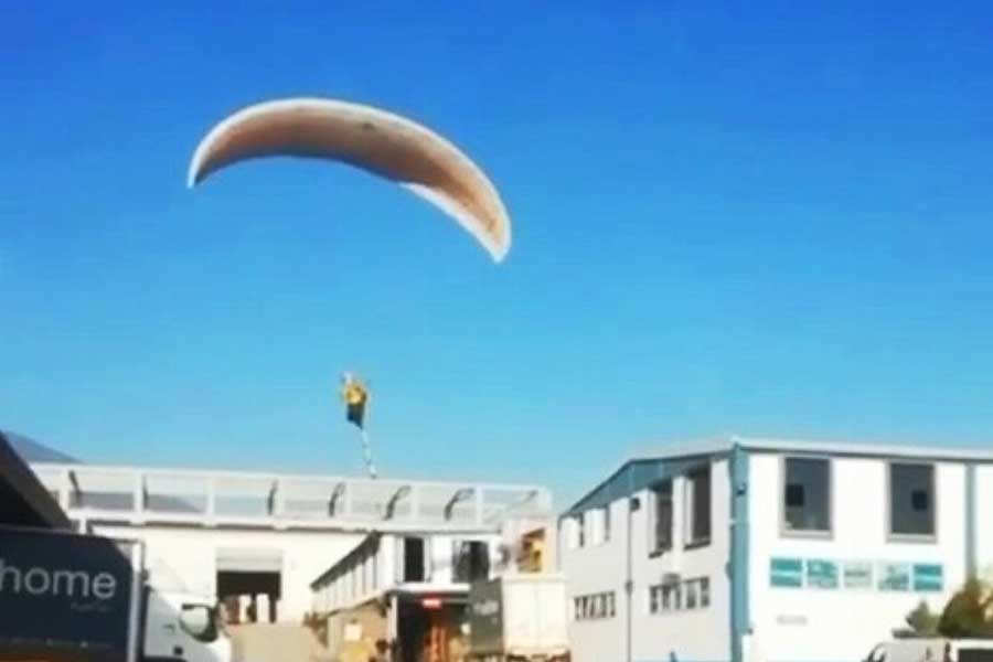 Turkey, man commutes paragliding