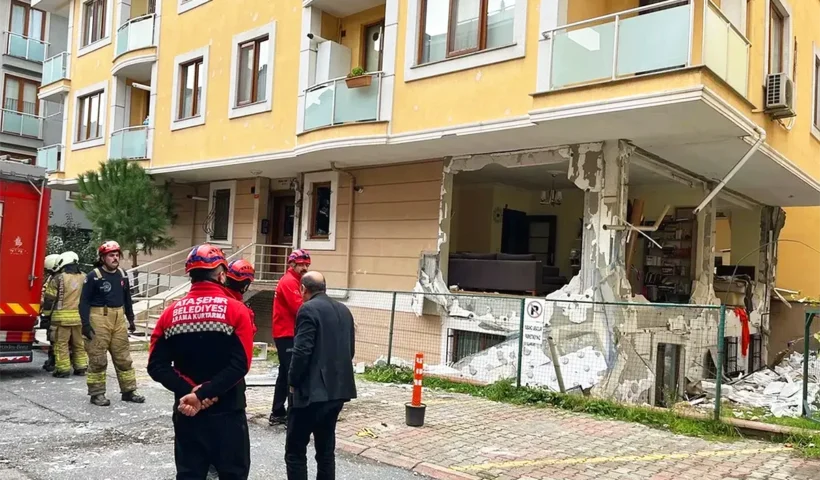 Firefighters stand next to a house destroyed by a gas explosion in Istanbul.