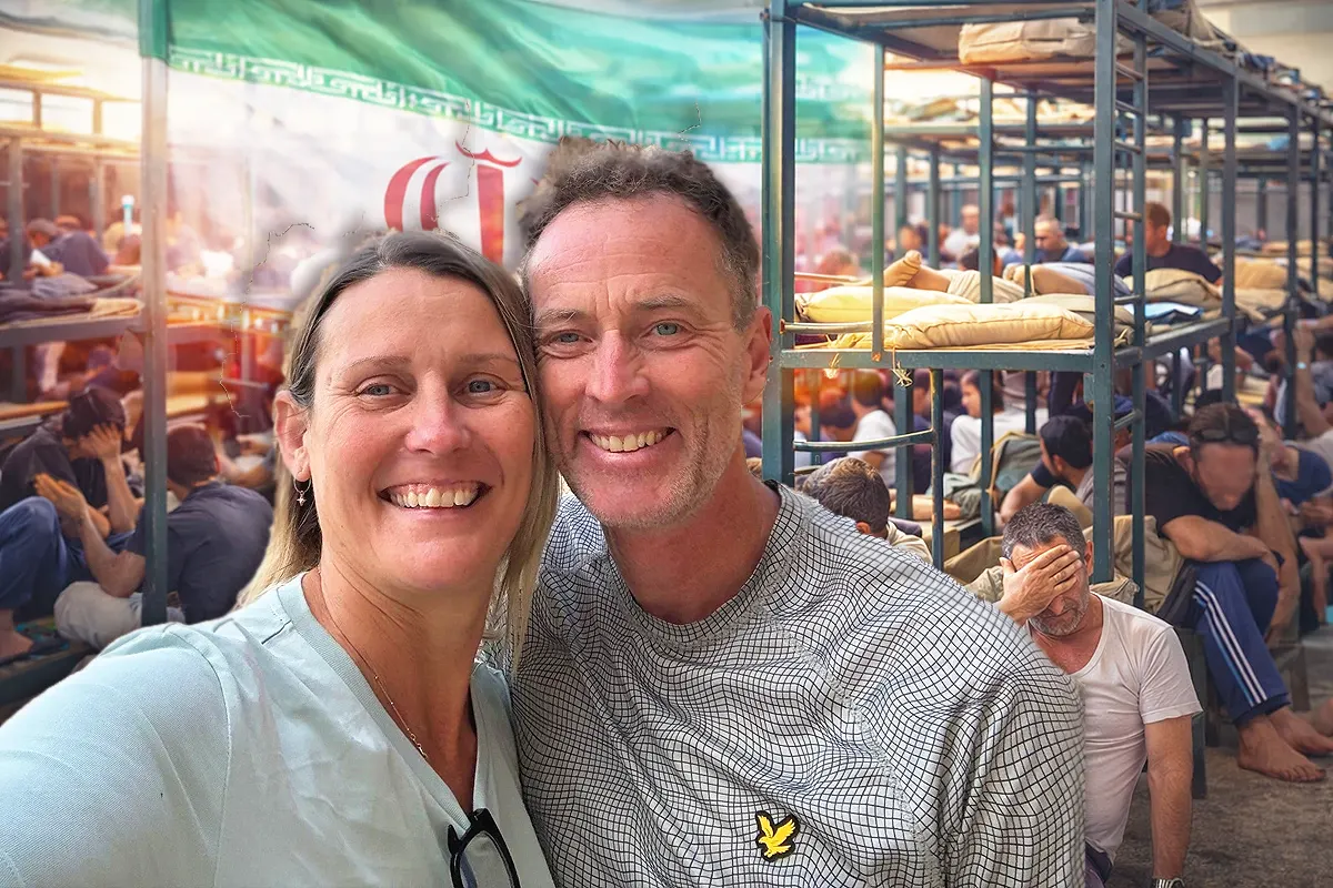 Image of British couple Lindsay and Craig Foreman, in the background inside an Iranian prison next to an Iranian flag.