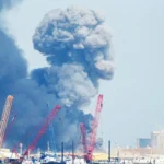 a plume of smoke rising from a US base facility in Bahrain attacked by Iran