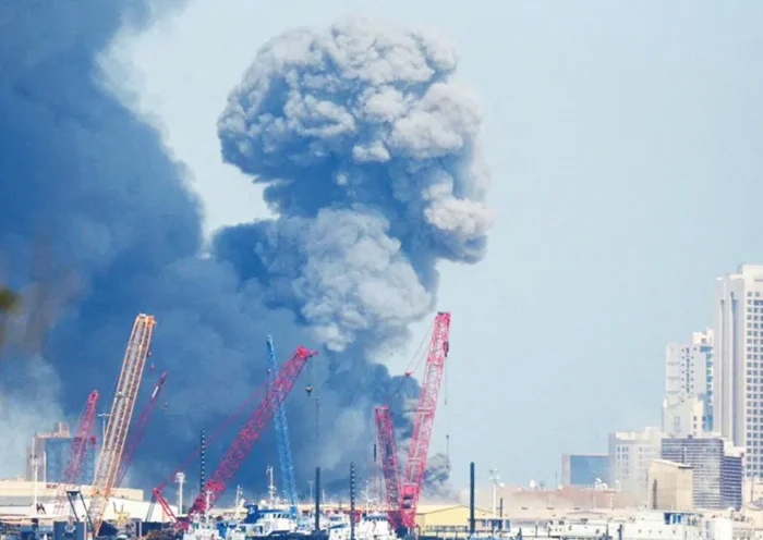 a plume of smoke rising from a US base facility in Bahrain attacked by Iran