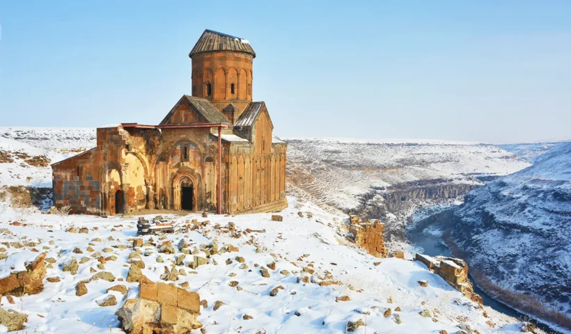 The ancient church of St Gregory in the ruins of Ani, surrounded by snow and next to a ravine on the border between Turkey and Armenia.