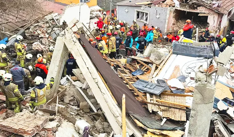 dozens of rescue team members work amidst the wreckage of ruined buildings