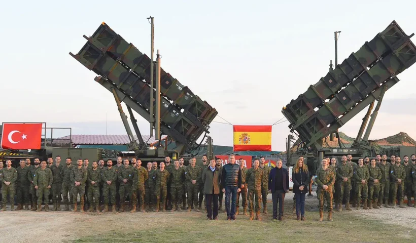 Spanish military alongside a Patriot defence system and the flags of Spain and Turkey.