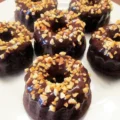 dessert of mini Savarin sponge cakes covered with chocolate and almonds