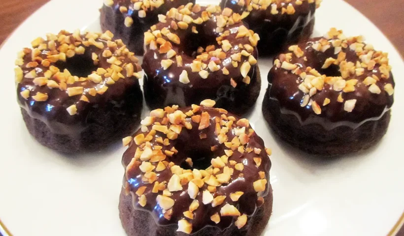dessert of mini Savarin sponge cakes covered with chocolate and almonds