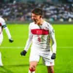 Arda Güler celebrates on the pitch wearing the Turkish national team shirt