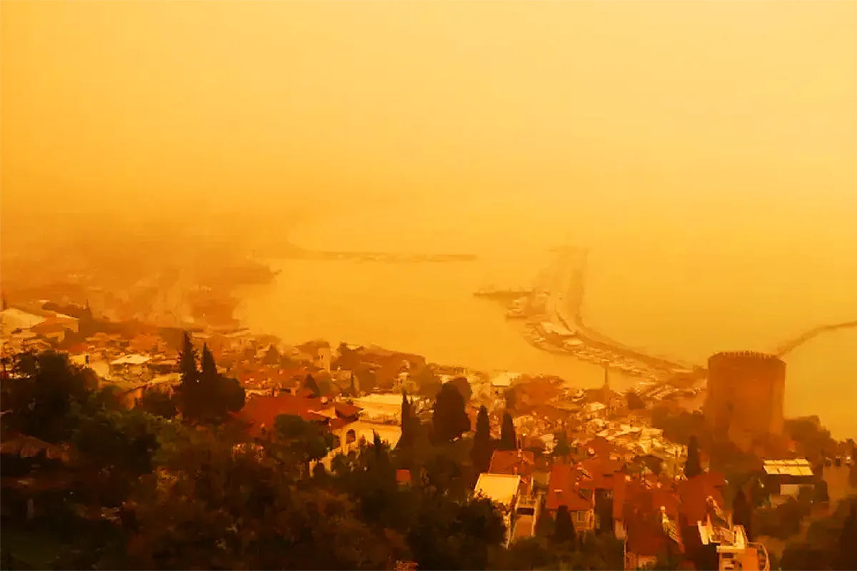 A bird's-eye view of Alanya Harbour in Antalya, with the air completely shrouded in an orange haze due to a dust storm