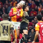 Galatasaray and Kocaelispor players battle for the ball with their heads during a league match