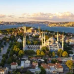 A view from the Fatih district, showing Istanbul's historic center with the Blue Mosque in the foreground and Hagia Sophia and the Bosphorus in the background