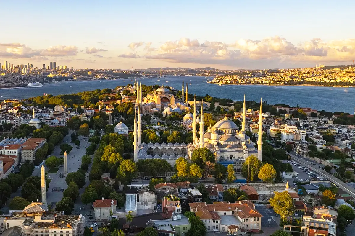 A view from the Fatih district, showing Istanbul's historic center with the Blue Mosque in the foreground and Hagia Sophia and the Bosphorus in the background
