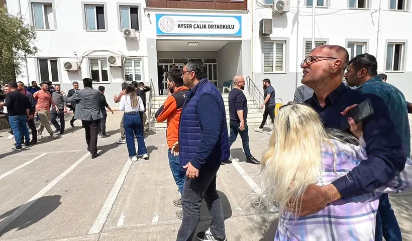 Several distraught parents outside a school in Kahramanmaraş, in south-eastern Turkey, where an attack left nine people dead