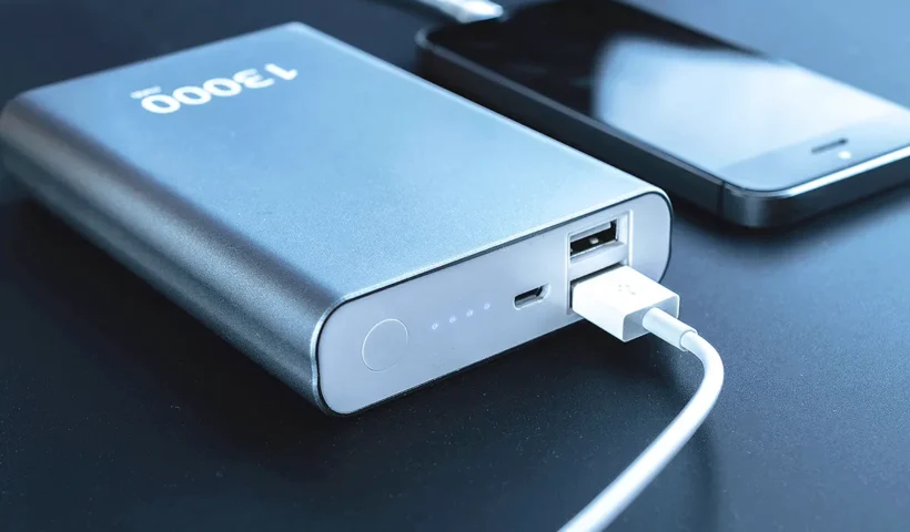 a power bank or external battery connected to a mobile phone via a cable