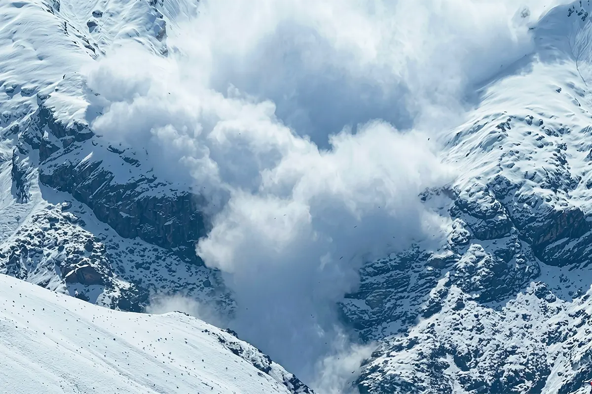 a massive avalanche of snow cascading down a snow-covered mountain