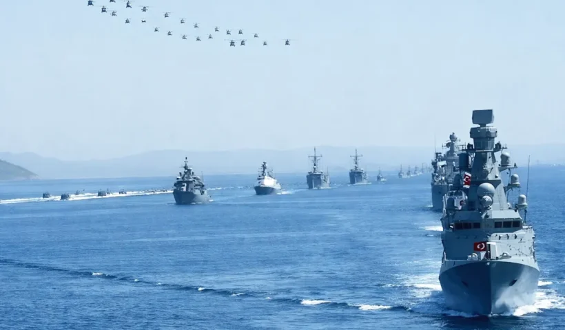 dozens of military vessels and aircraft flying over the sea during Turkish naval exercises