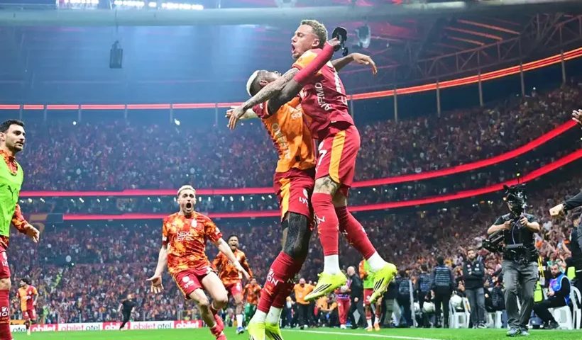 Osimhen celebrates by hugging a teammate, elated at the goal that secures victory for Galatasaray and crowns them champions