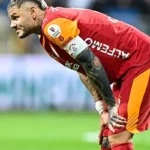 Icardi, wearing the Galatasaray shirt, looks resignedly ahead on the pitch after his team conceded a goal