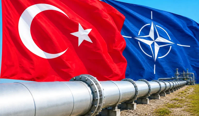 a close-up shot of a large oil pipeline, with the flags of Turkey and NATO in the background