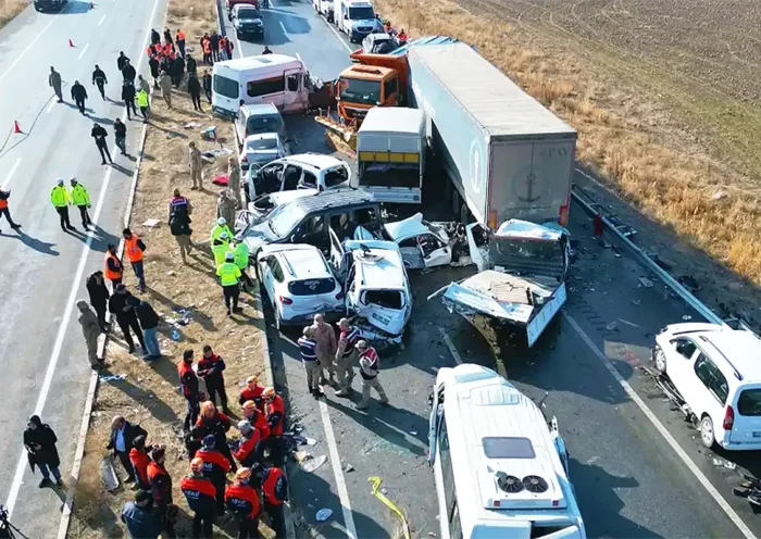 Aerial view of a multi-vehicle collision involving cars and trucks on a highway