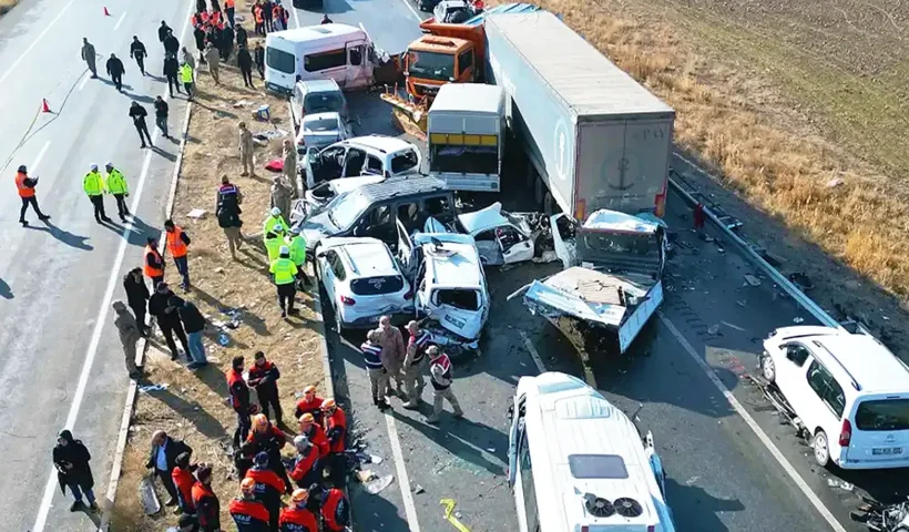 Aerial view of a multi-vehicle collision involving cars and trucks on a highway
