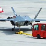 A Turkish Bayraktar KIZILELMA combat drone being transported across a runway