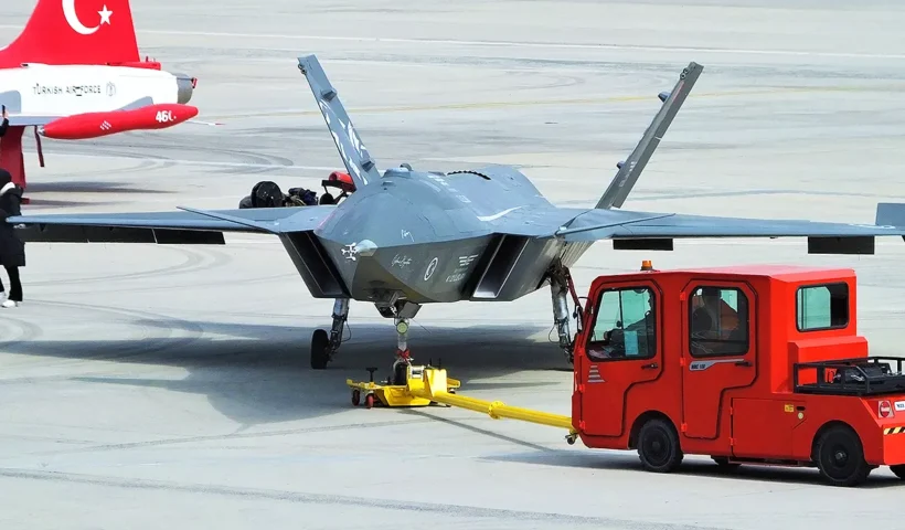 A Turkish Bayraktar KIZILELMA combat drone being transported across a runway