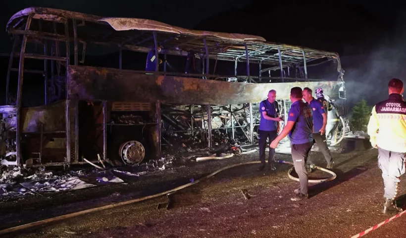 Several emergency responders on the scene overnight next to the remains of a completely burned-out bus