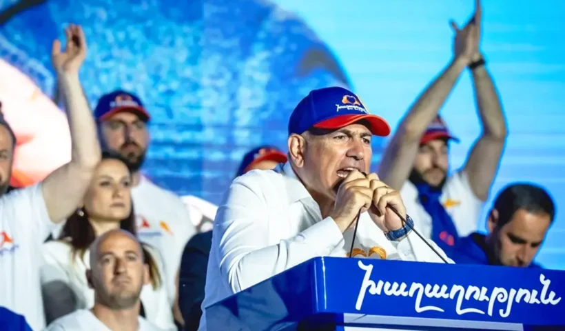 el primer ministro armenio Nikol Pashinyan habla desde un podio a seguidores de su partido durante la campaña electoral