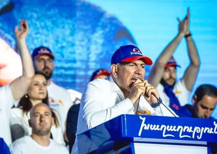 Armenian Prime Minister Nikol Pashinyan addresses supporters of his party from a podium during the election campaign
