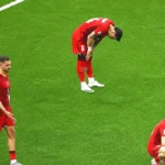 players from the Turkish national football team slumped on the pitch