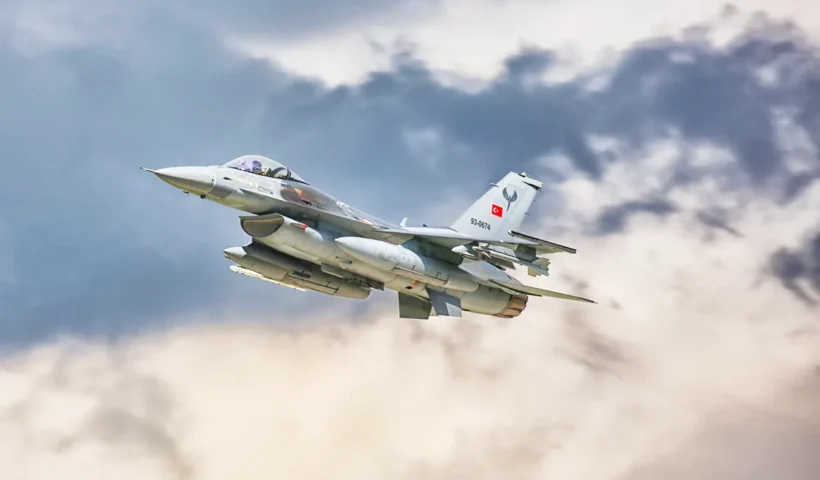 a Turkish F-16 fighter jet flying through the clouds