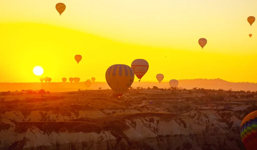 hot-air balloons taking off at a spectacular sunrise in Cappadocia