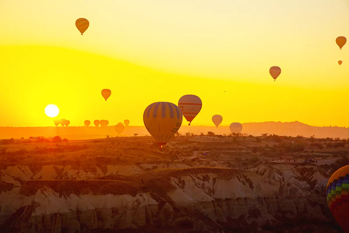 hot-air balloons taking off at a spectacular sunrise in Cappadocia