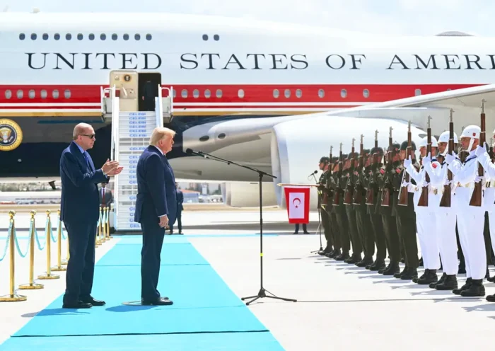 Erdoğan alongside Trump during a ceremony in front of Turkish soldiers; the US presidential aircraft, Air Force One, can be seen in the background