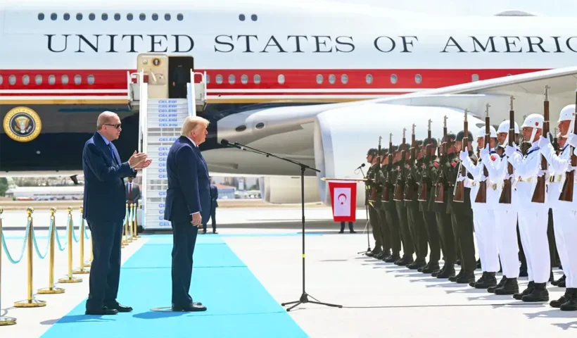 Erdoğan alongside Trump during a ceremony in front of Turkish soldiers; the US presidential aircraft, Air Force One, can be seen in the background