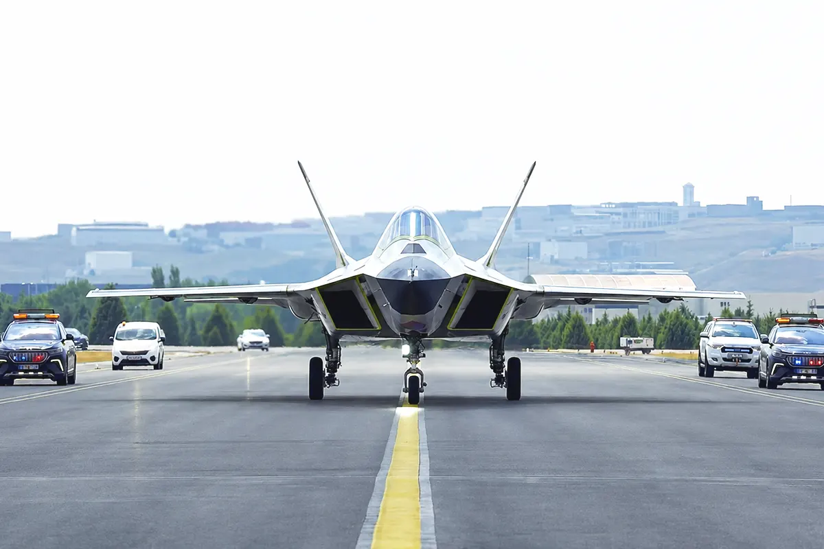 a front view of a prototype of the Turkish KAAN fighter jet taxiing down a runway