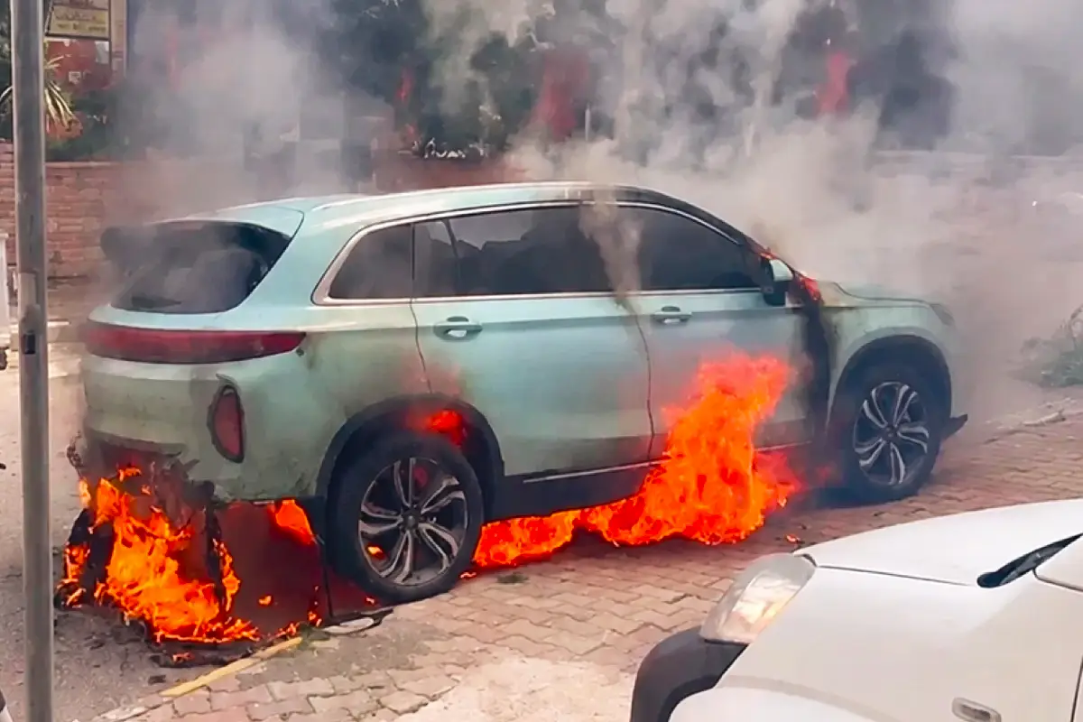 a Skywell ET5 electric car on fire in the street