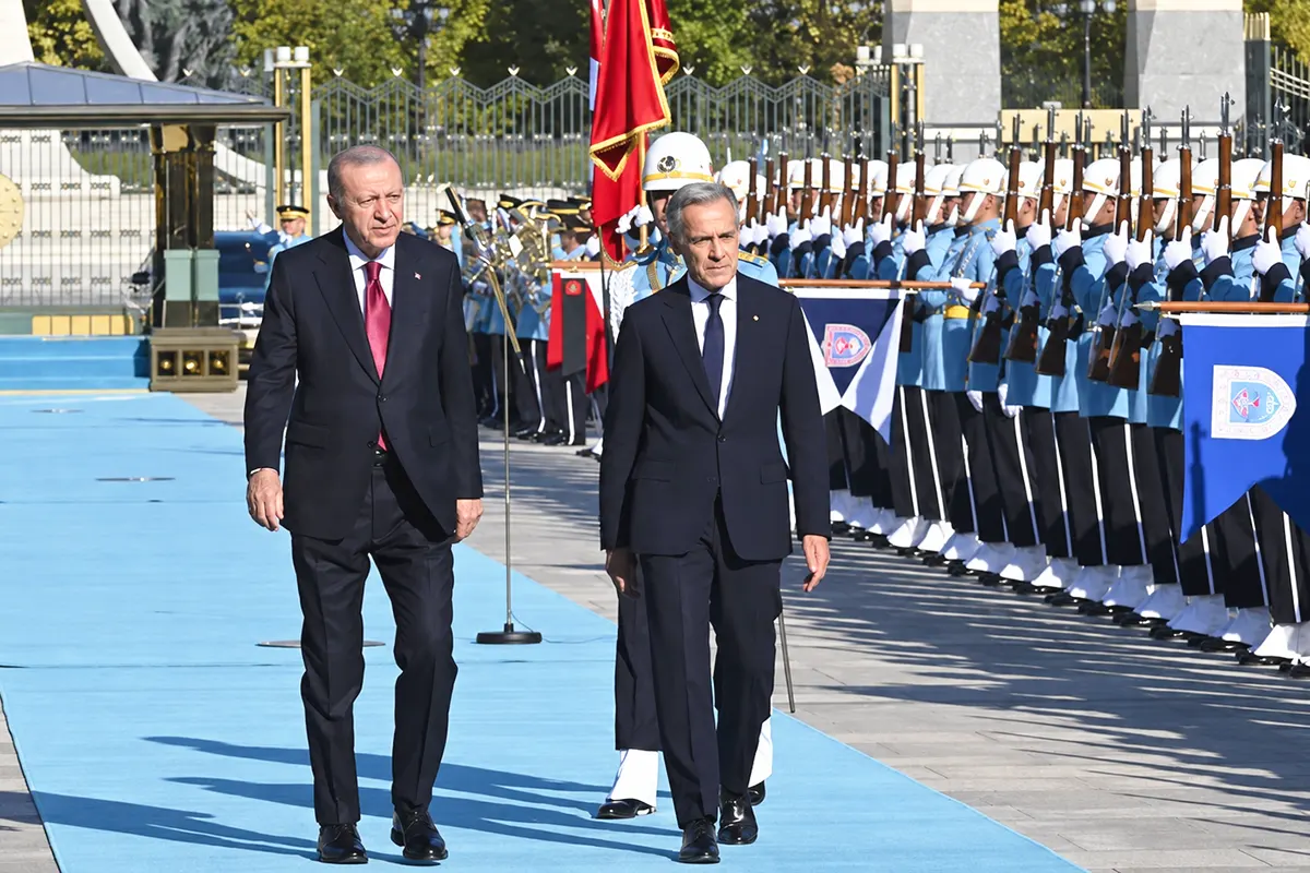 Erdoğan and Carney walk alongside several soldiers during an official ceremony at the presidential palace in Ankara