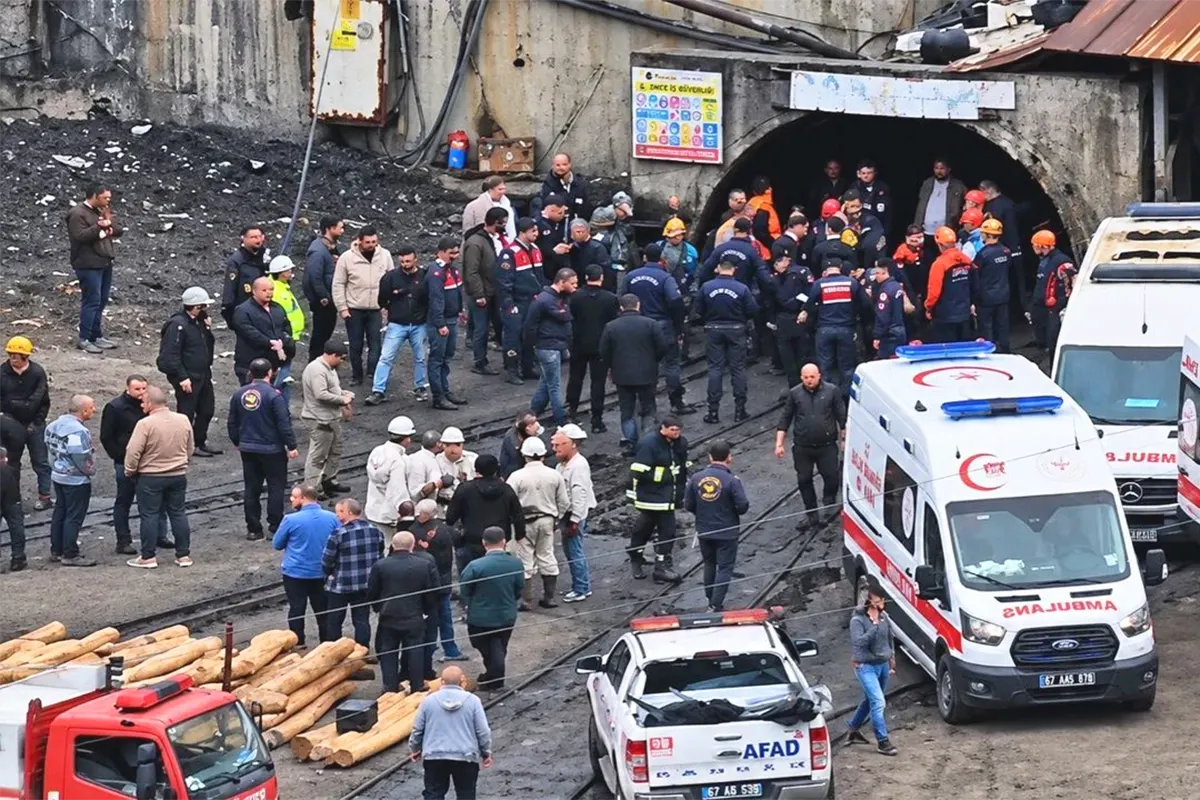 Dozens of people, including rescue teams, miners and relatives, are waiting alongside several ambulances at the entrance to a coal mine